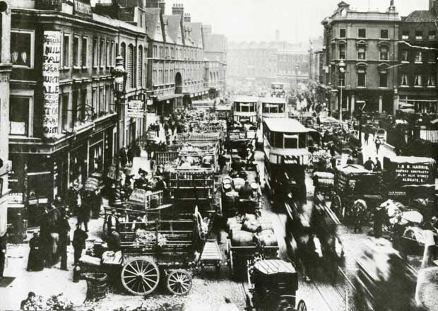 Commercial Street Spitalfields busy with horses and carts in 1888.