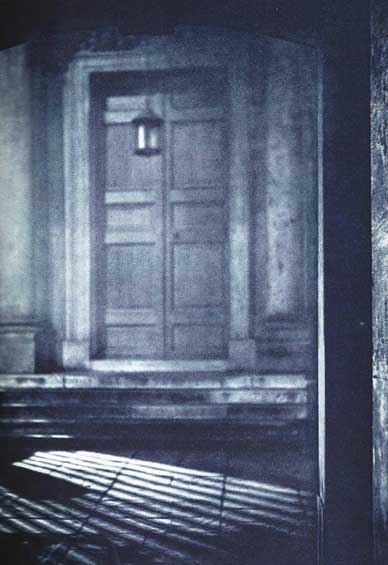 A black and white image of a door in one of the old courtyards that we pass through on the ghost walk.