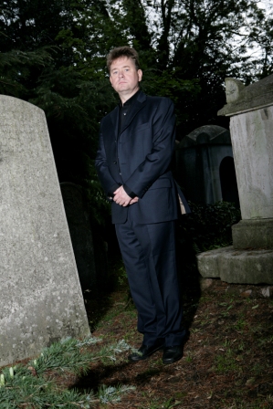 London ghost walk guide Richard Jones in a graveyard.