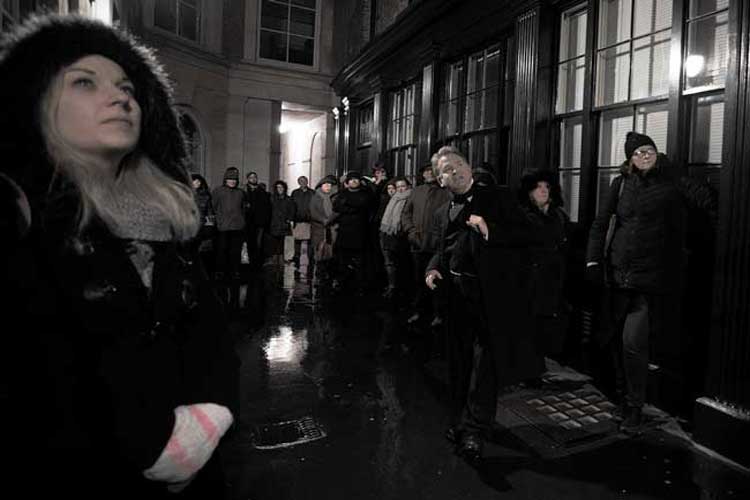 A ghost walk group in an old alley.