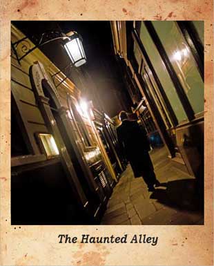 Richard Jones dressed in his ghost walk attire walking through one of the City's alleyways.